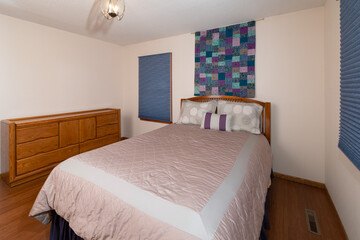 bedroom interior with queen bed and bamboo hardwood floors