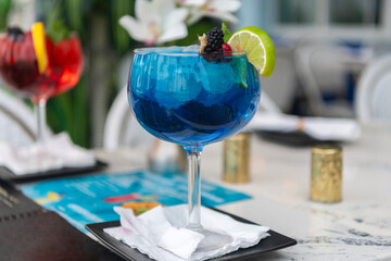 Blue lagoon cocktail. Blue lagoon drink. Aperitif in the bar. Summer refreshing cocktail. Drinking blue lagoon. Glass of blue lagoon aperitif beverage. Summer drink. Cocktail in bar. Luxury serving