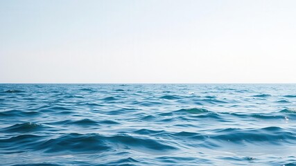 Obraz premium Tranquil ocean waves rippling under clear sky, peaceful water surface, ocean, clear sky, peaceful