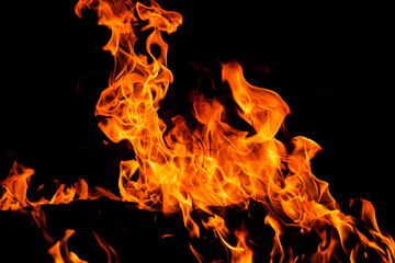Fire flames on black background. Fire sparks background. Abstract dark fire flames background. Background of flames blazing.