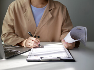 Fototapeta premium Businesswoman employer holding resume, recruiting, planning, evaluating and reviewing resume of job applicant, recruiting new employees, recruitment concept