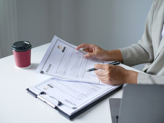 Businesswoman employer holding resume, recruiting, planning, evaluating and reviewing resume of job applicant, recruiting new employees, recruitment concept