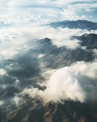 Fototapeta premium A photo taken from the height of a drone flight, showing mountains, clouds, and settlements