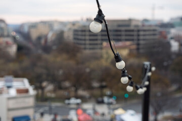 string lights on a rooftop in a city