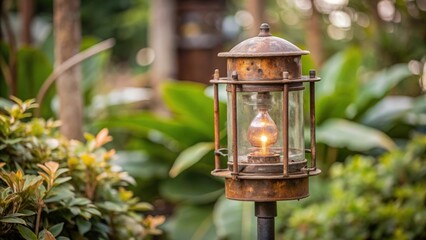 Fototapeta premium Rusted Outdoor Lantern with a Lit Bulb in a Garden Setting