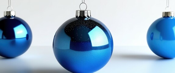 Photo of three shiny blue Christmas baubles on a white background, one in the foreground, one in the middle, and one in the background, soft lighting, high quality, jpeg artifacts