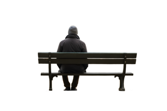 Lonely senior man sits alone on a park bench.