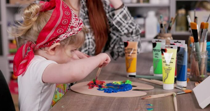 Engaging in creative child painting activity inside an art studio environment is delightful