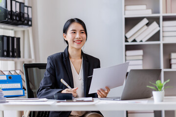 Business asian woman working at office with documents on desk, doing planning analyzing the financial report, business plan investment, finance analysis concept	
