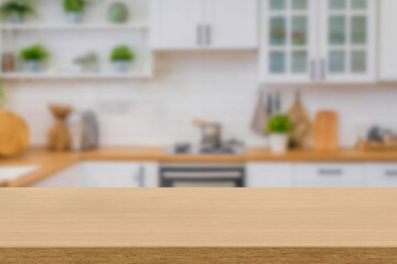 Kitchen wood table top for product display with blurred modern interior. Wooden tabletop over defocused kitchen background. kitchen furniture and desk space. product promotion in the kitchen