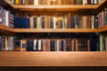 empty wooden table top blurred library or book store setting with books and reading material.Wooden tabletop over defocused bookcase background. product promotion in the library.