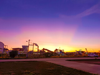 oil refinery at sunset