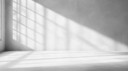 Fototapeta premium Versatile white and grey studio interior background with product displays and natural window shadows ideal for text insertion, product presentations, and professional photography backdrops