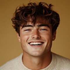 Fototapeta premium A young man with casual t-shirt is smiling at the camera, solid color background