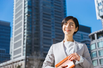 Fototapeta premium 手帳を持つ自身を持った表情の女性