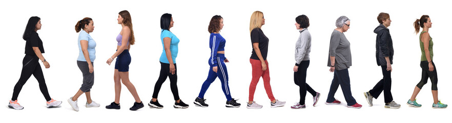 Obraz premium side view of a group of women walking on white background