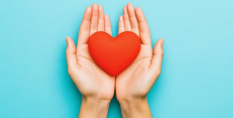 Obraz premium Top view flat lay of female hands holding red heart on blue background