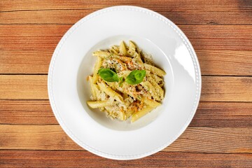 Tasty creamy pasta with cheese in plate.