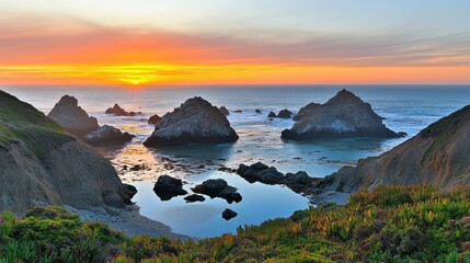 Fototapeta premium Vibrant Sunset Over Rocky Seascape and Tranquil Tide Pools