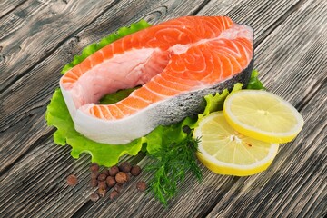 Raw tasty fish steak with cooked vegetables