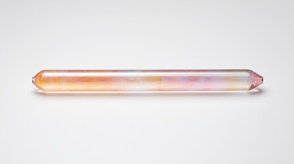 A colorful, elongated crystal wand with a smooth surface, showcasing gradient hues of pink, orange, and clear tones against a simple background.