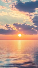 Sunset over calm ocean with dramatic clouds