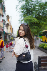 back view of two asian women walking on street