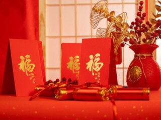 Chinese new year festival decorations with red bags, oranges and red Chinese folded fans on white marble background. Celebrate Happy Chinese new year. All Brushscript Texts in Chinese meaning luck.