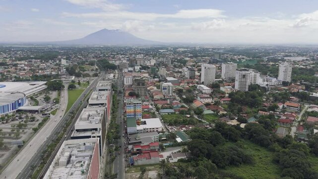 Fly sideways over Angels City with Mount Arayat in the background, The Philippines