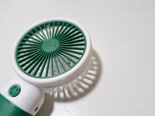 isolated object of white and green mini fan