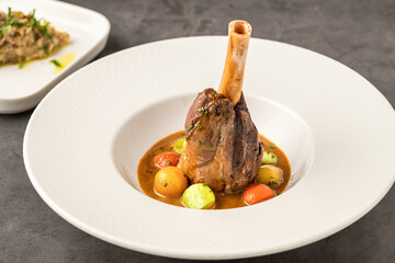 Traditional slow-cooked braised lamb knuckle or lamb shank with sauces
