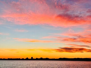 a pink sunset clouds over the sea