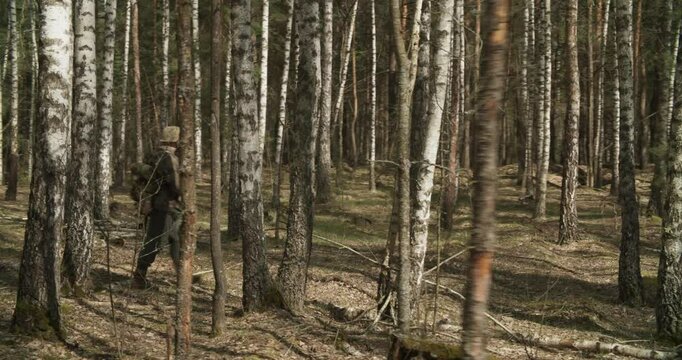 Reenactor Dressed As German Infantry Soldier Combing Forest. Soldier With Carabines Mauser 98k Going By Forest. Reenactment Tactic Game Autumn Season. Wermacht Military Uniform