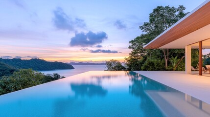 Fototapeta premium Scenic view of a modern villa with infinity pool at sunset.