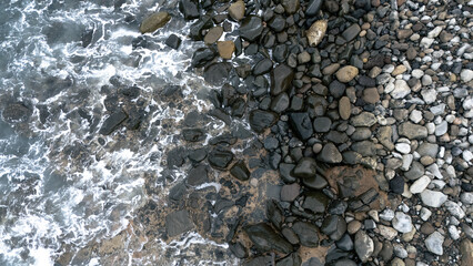 View from above of a pebble beach in winter time