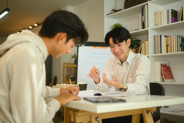 Tutor and student sharing ideas and discussing study materials during a home tutoring session