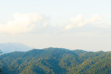 serene mountain landscape with lush green hills and soft clouds. tranquil scene evokes sense of peace and natural beauty, perfect for nature lovers