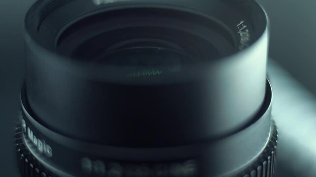 Low aperture camera optic lens flare Macro slow motion video tilt down movement, 120 fps