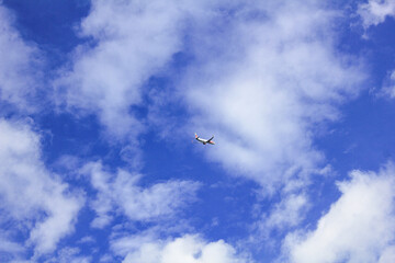  plane passes above the blue sky cloudy