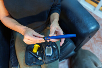 Close up of a woman preparing an insulin pen, showcasing diabetes management and treatment