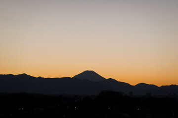 The silhouette of Mount Fuji as seen from central Tokyo
