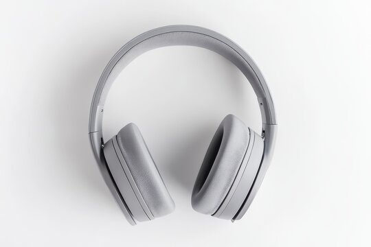 Folded gray wireless headphones with a modern design on a neutral background