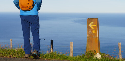 Pilgrim on the Camino de Santiago. Hiker on the Northern Way by the sea, Mount Jaizkibel, Euskadi.