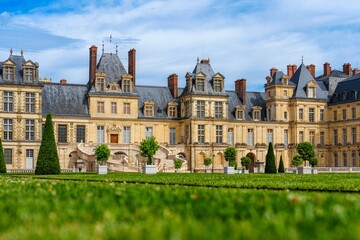 Fototapeta premium Chacteau de Fontainebleau in Fontainebleau, France, is a stunning UNESCO World Heritage Site. This majestic palace reflects the rich history of French royalty and attracts many visitors.