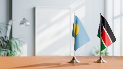 FLAGS OF PALAU AND SOUTH SUDAN ON TABLE