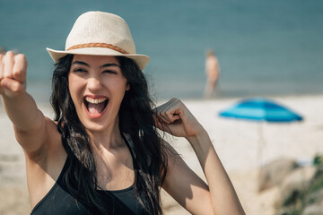 Woman in hat happy on the beach, happy pretty young woman on vacation, vacation concept