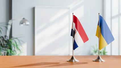FLAGS OF PARAGUAY AND UKRAINE ON TABLE