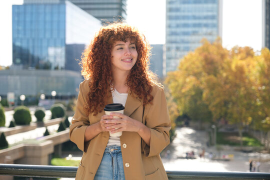 Happy businesswoman holding coffee cup enjoying during break time