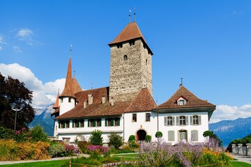 Schloss Spiez, a historic castle in Switzerland, showcases medieval architecture and offers breathtaking views of the mountains and Thun Lake, inviting visitors to explore its rich past.