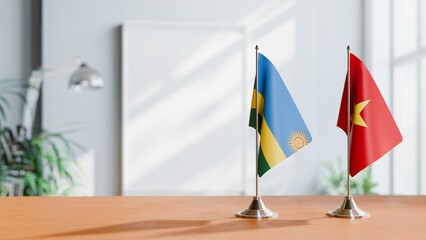 FLAGS OF RWANDA AND VIETNAM ON TABLE